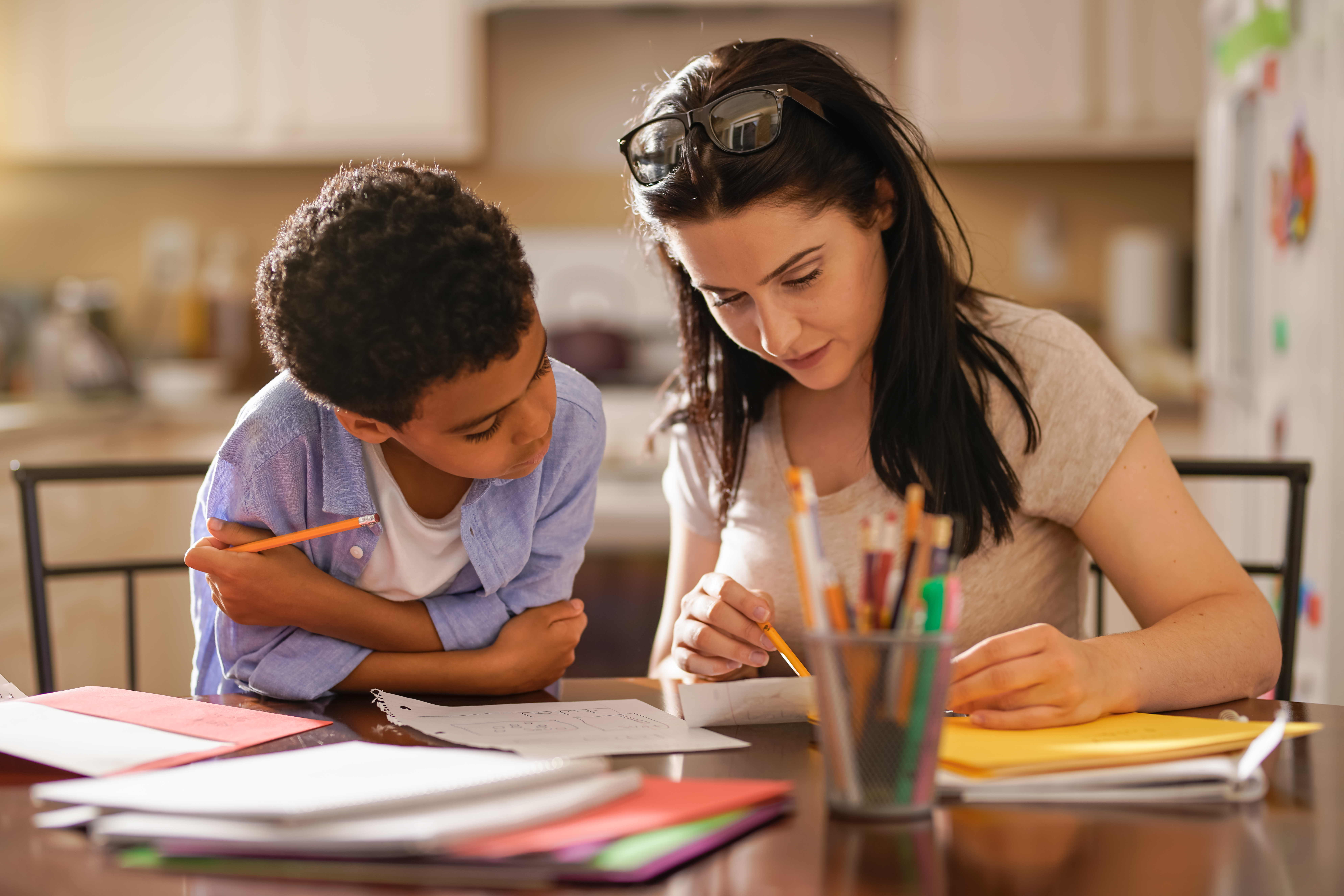 Woman Assisting Son In Doing Homework
